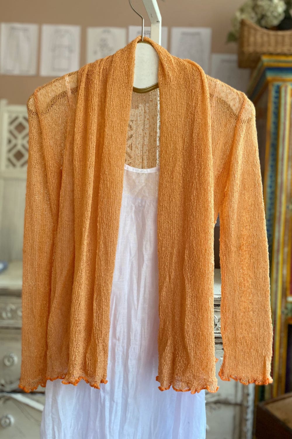 Loose knit apricot crop shawl.