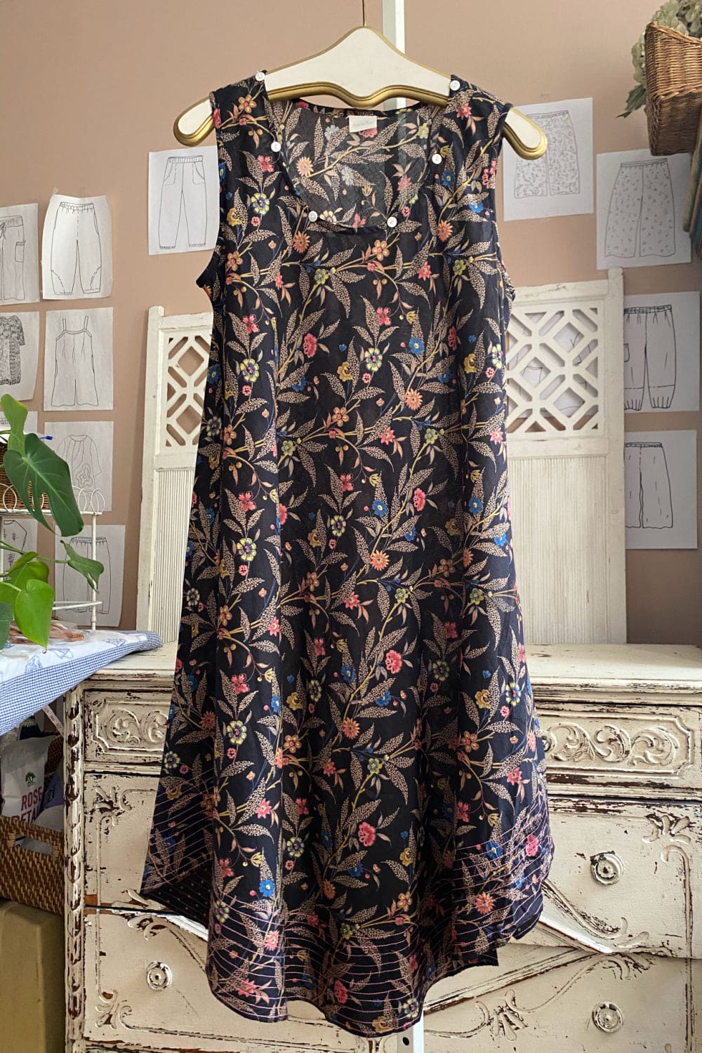 Black curved hem tank dress in a pretty floral pattern.