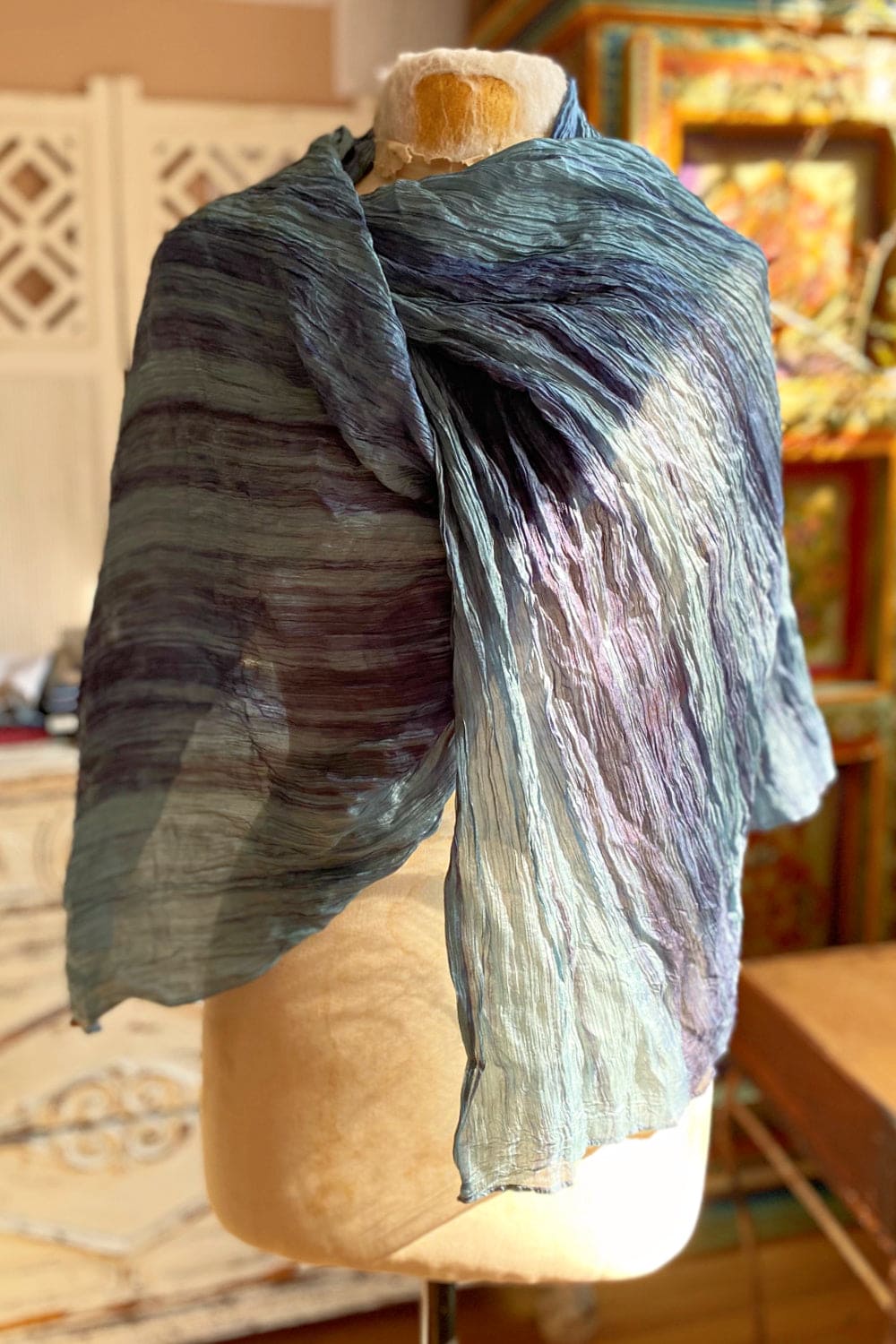 Blue and Purple Rainbow scarf drapped over a antique dress form.