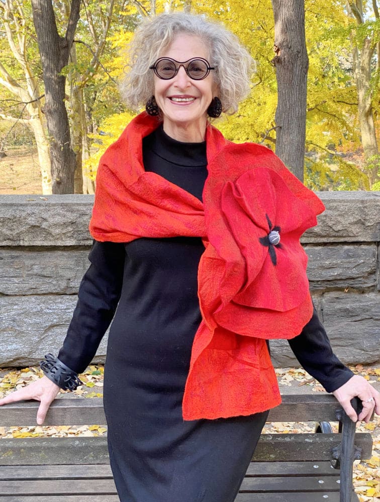 Red Felted scarf wth dramatic flower worn on a stylish older woman.