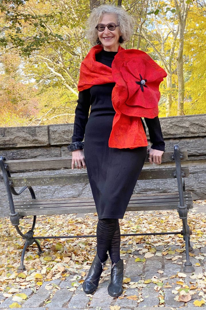 Red Felted scarf wth dramatic flower worn on a stylish older woman.