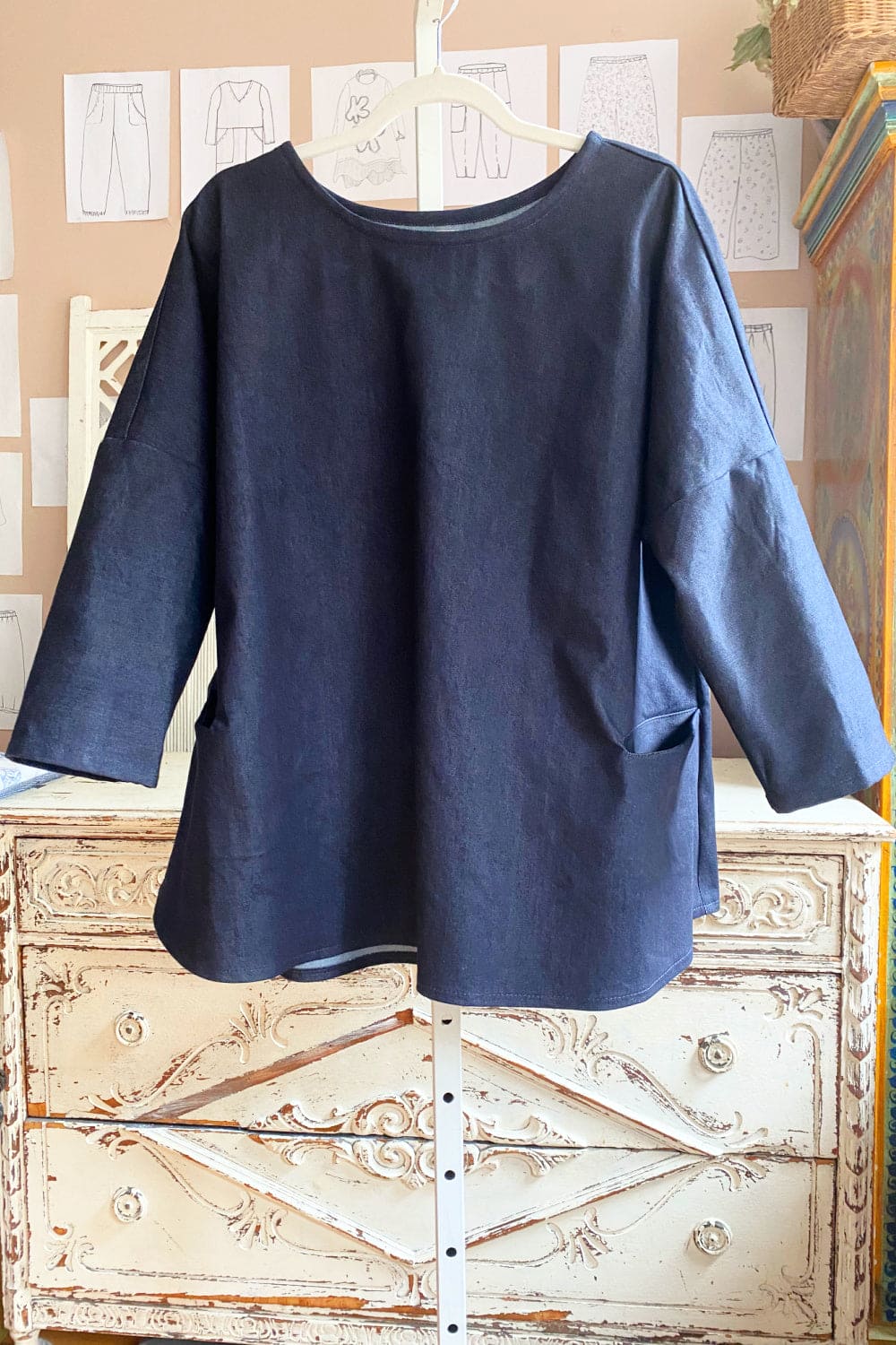 Aline top with two front pockets and long sleeves.