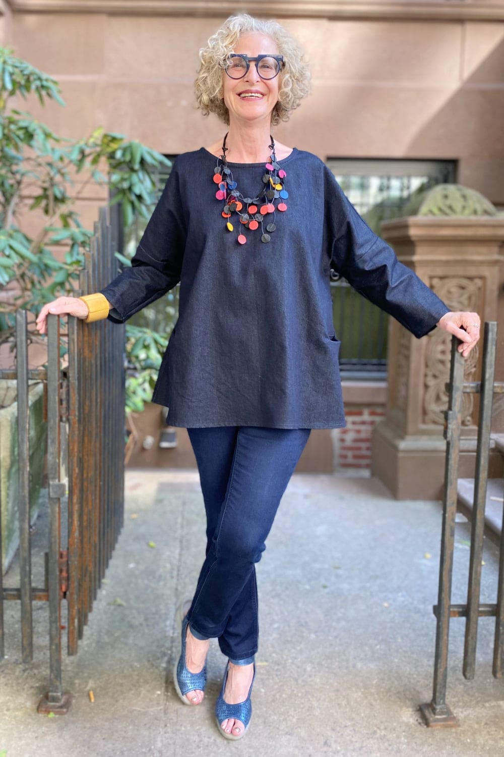 Aline denim top worn with denim jeans and fun statement necklace.