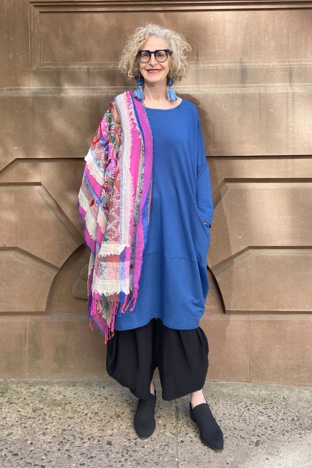 Blue bubble shape dress styled with pink scarf and blue  tassel earrings.