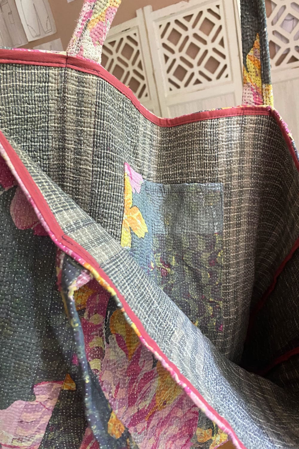 Inside of large pink floral kantha tote bage with inside pocket