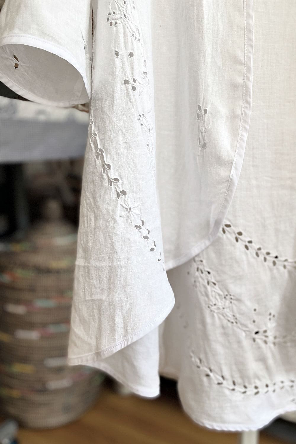 Bottom detail of white vintage tablecloth jacket.