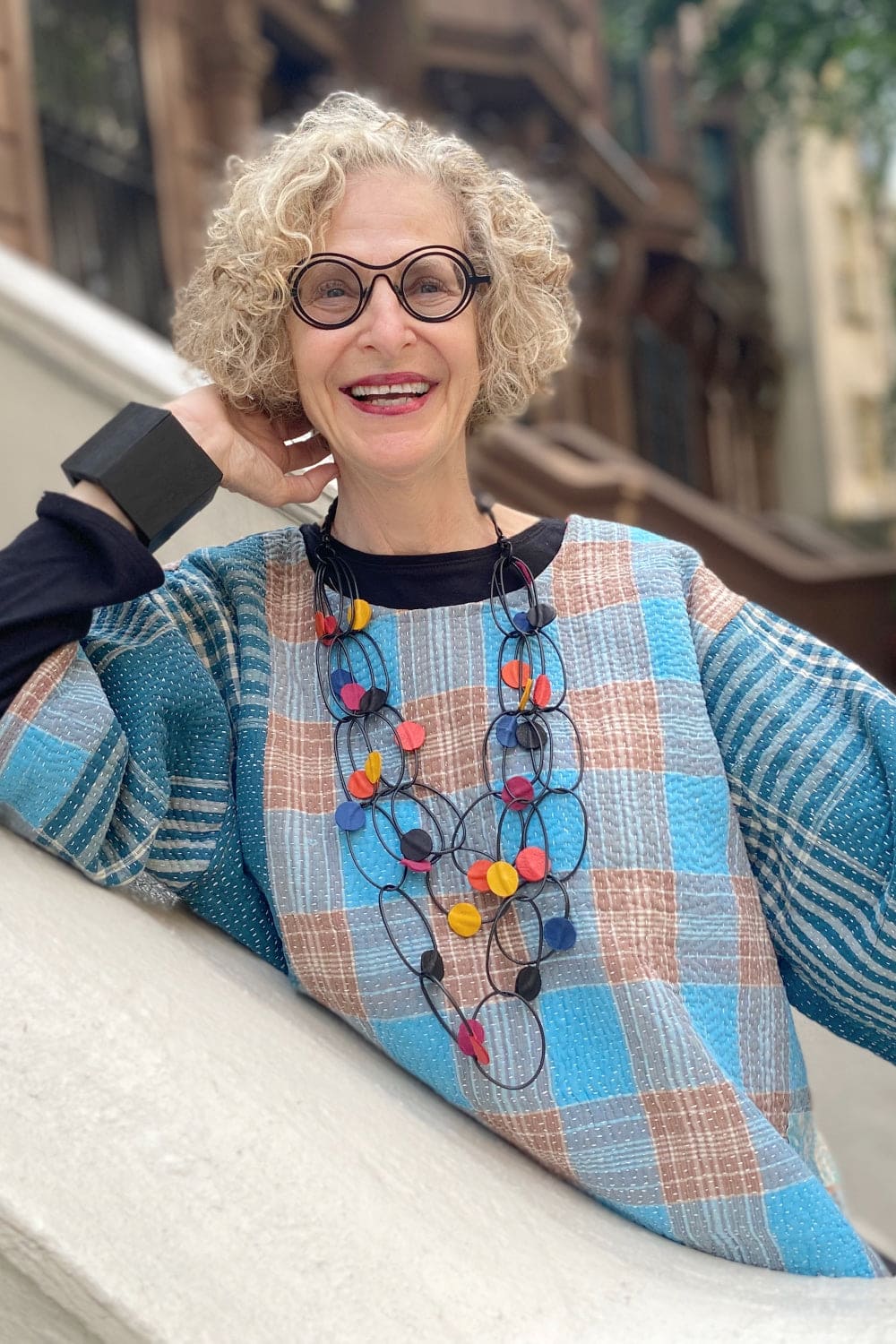 Blue plaid cotton kantha top worn with funky necklace.