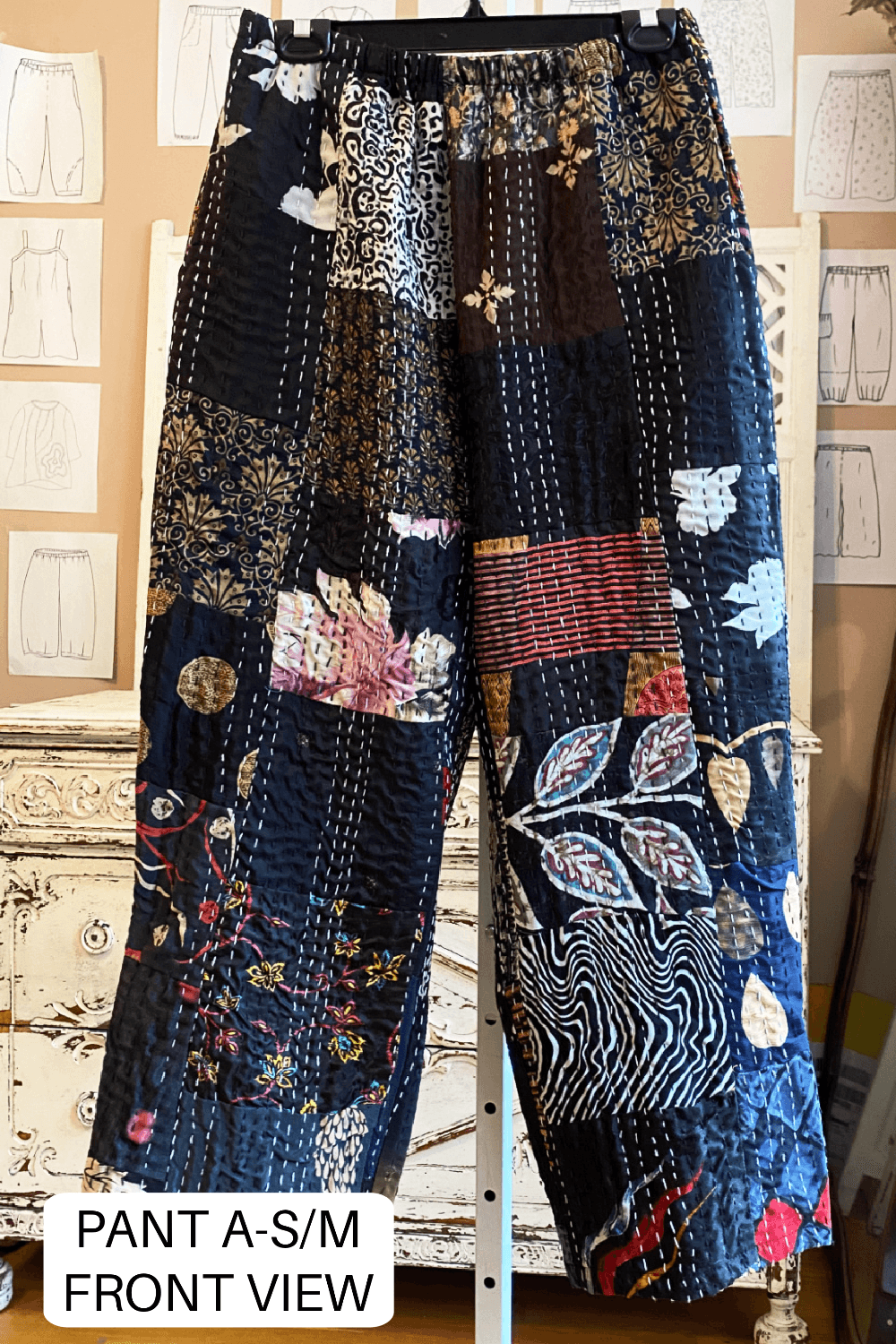 Fun patchwork kantha pants with lots of prints and colors on a black background.