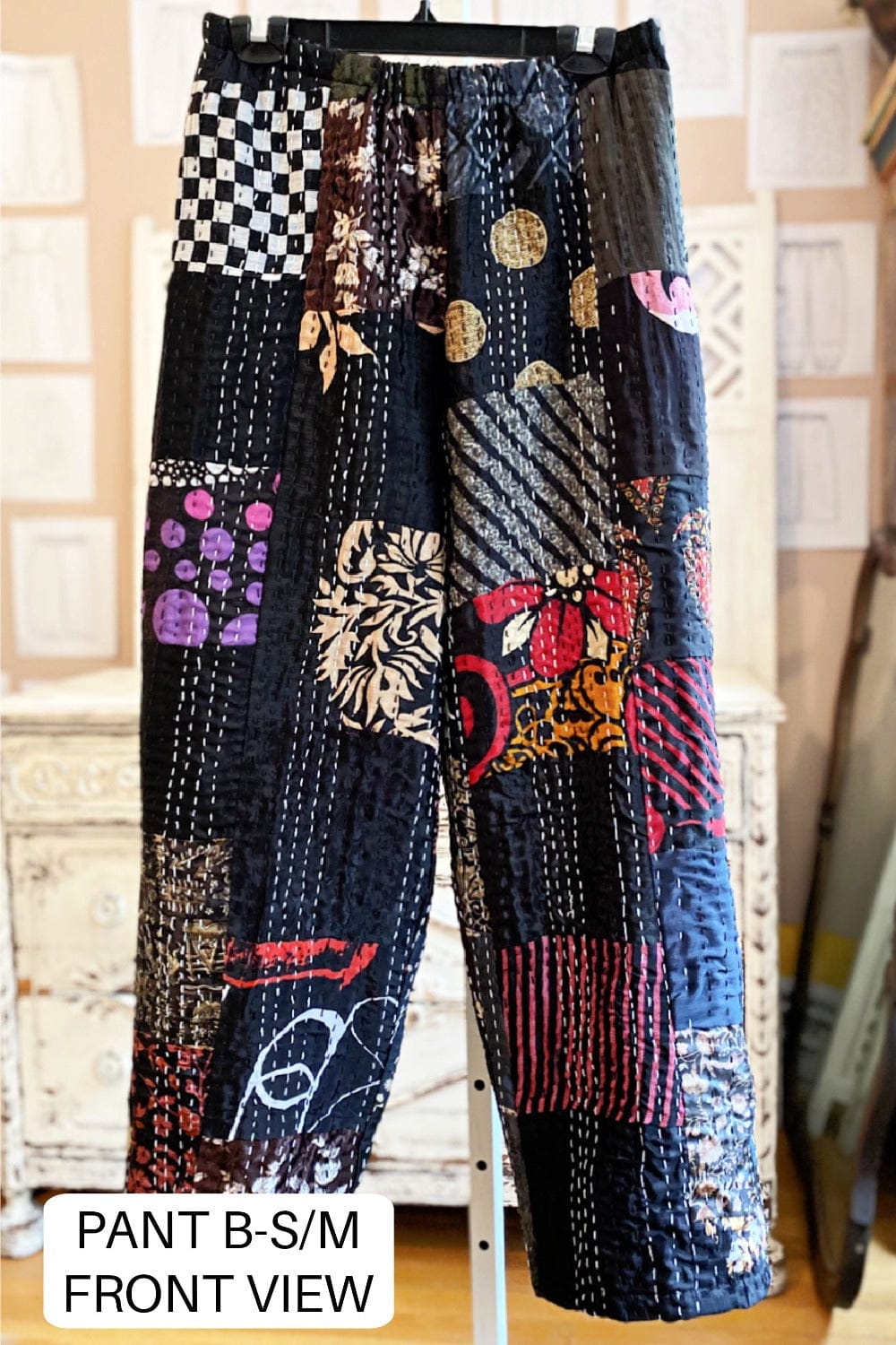 Fun patchwork kantha pants with lots of prints and colors on a black background.