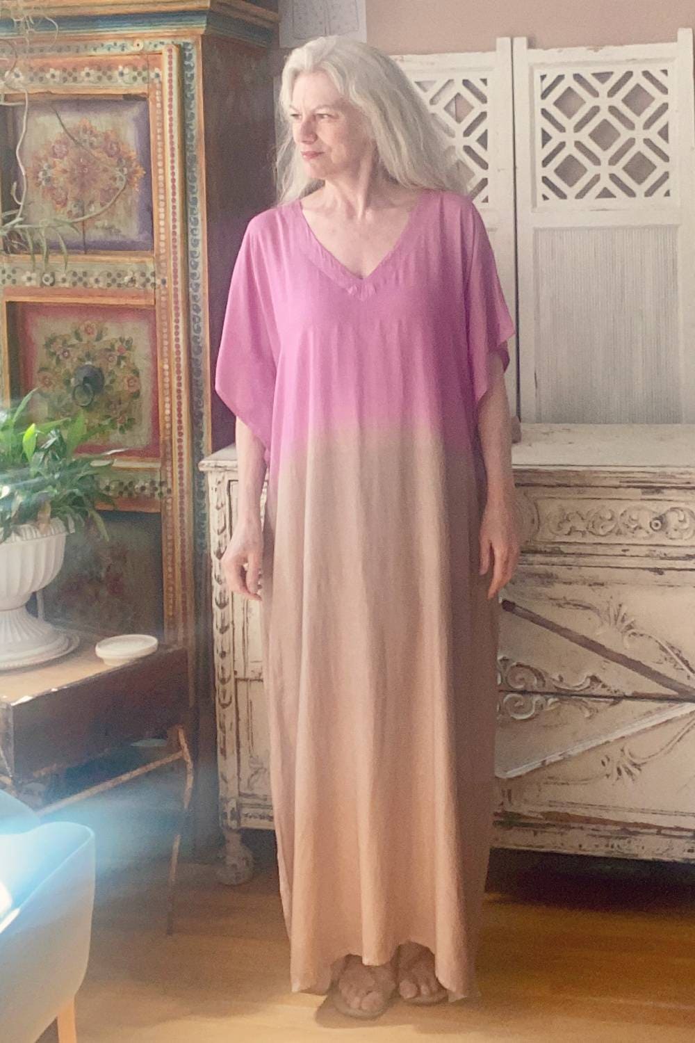 Pink & Taupe women's caftan with an ombred design worn by an older woman with long grey hair.