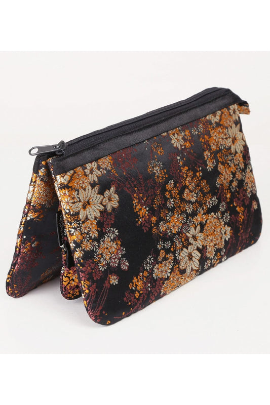 Three pouch makeup bag in a pretty floral print with a black background and a black top zipper.