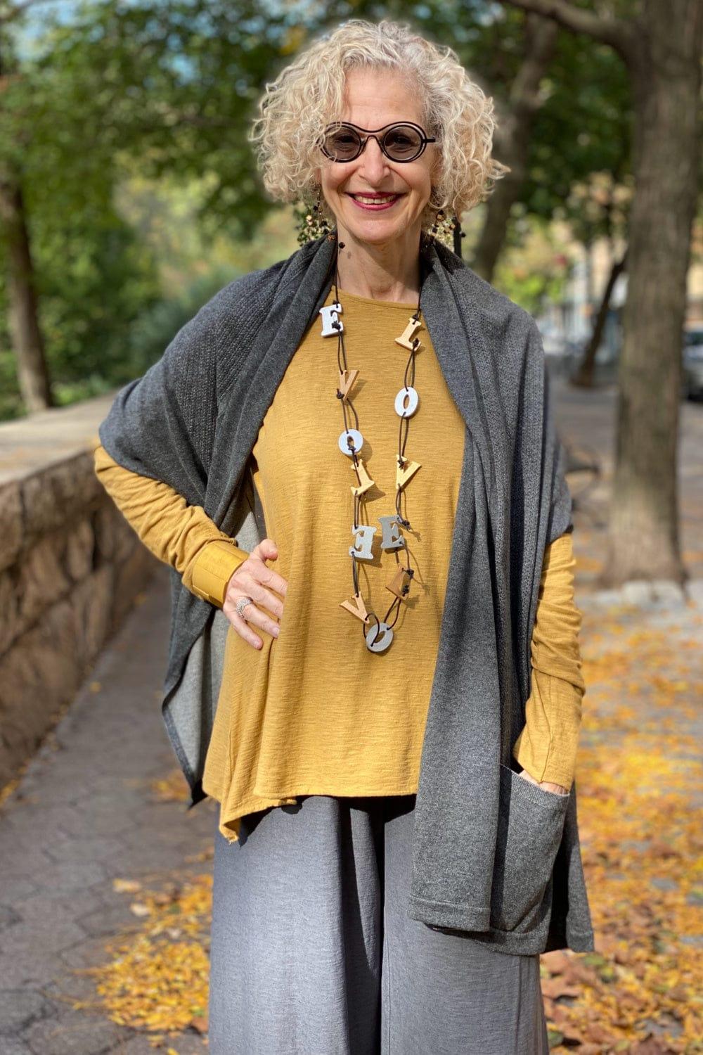 Two Pocket Knit Women's Shawl styled with a mustard longsleeve top and grey pants.